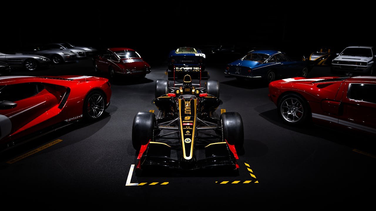 services-03 Showroom display of high-performance racing cars in a dramatic setting.